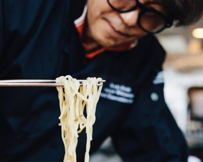 Junya inspecting noodles